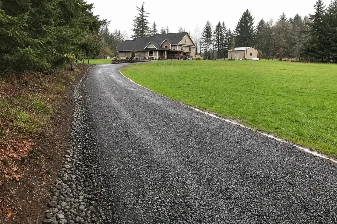 New crushed-rock gravel driveway with drainage on a rural Vancouver, WA property